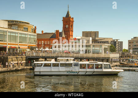 CARDIFF BAY, WALES - JULY 2018: Wide angle view of a small passenger ferry at the Mermaid Quay jetty in Cardiff Bay. Stock Photo