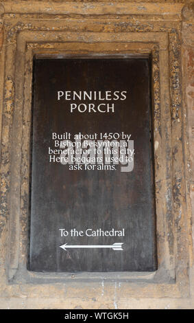 Sign in the Penniless Porch, built to beggars,  at the entrance to medieval Wells Cathedral  in the city of Wells, Somerset, England, UK Stock Photo