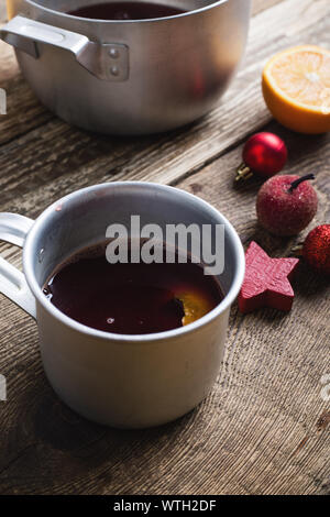 Mulled wine In rural bowl and mug on rustic wooden table, Christmas and Thanksgiving day cozy festive drink, close up, selective focus Stock Photo