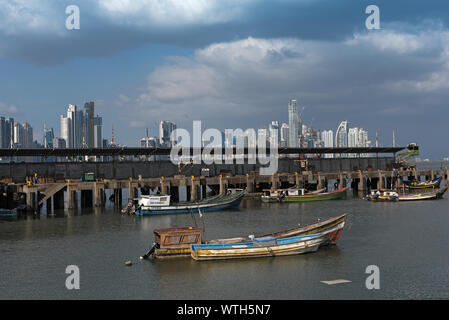 old fishing boats near fish market in panama city with skyline background Stock Photo