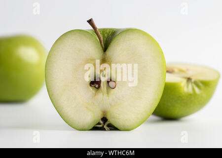 Fresh cut green apple over a white background, closeup Stock Photo