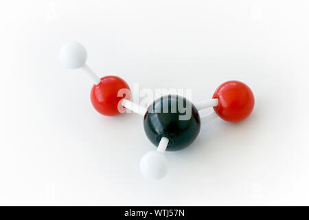 Plastic ball-and-stick model of a formic acid molecule (CH2O2) on a white background. Formic acid is also called methanoic acid and is the simplest ca Stock Photo