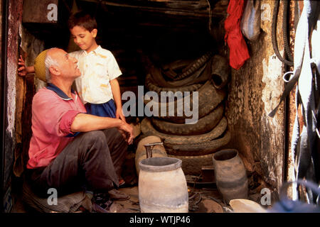 Grandfather and grandson in a repair shop. Stock Photo