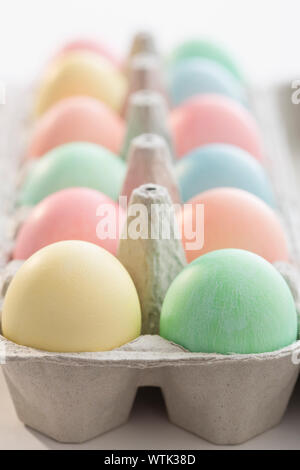 Pastel colored Easter eggs in carton Stock Photo