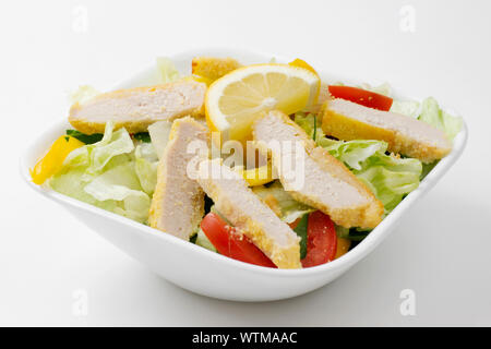 Chicken lettuce salad bowl with tomatoes, Cheese, and peppers. Stock Photo