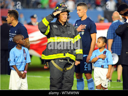 New York, NY, USA. 11th Sep, 2019. First Responders salute the flag before the NYCFC soccer game against Toronto FC at Yankee Stadium in New York, NY. Bennett Cohen/CSM/Alamy Live News Stock Photo
