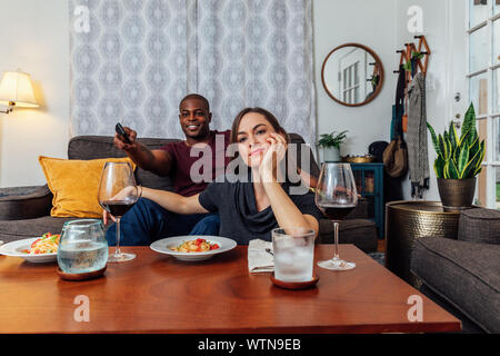 Couple having dinner and watching tv. Stock Photo