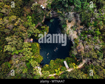 Unrecognizable group of people swimming in clean water Cenote Crystal Stock Photo