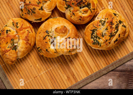 Appetizing garlic bread buns seasoned with cheese, onion, and garlic. Stock Photo