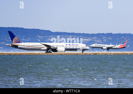 September 1, 2019 Burlingame / CA / USA - United Airlines aircraft preparing to take off and American Airlines aircraft landing at San Francisco Inter Stock Photo