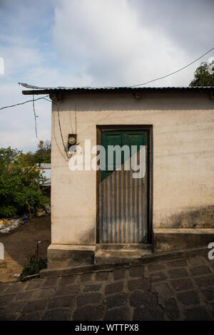 Small Building with Door of Half Metal and Green Wood in Guatemala Stock Photo