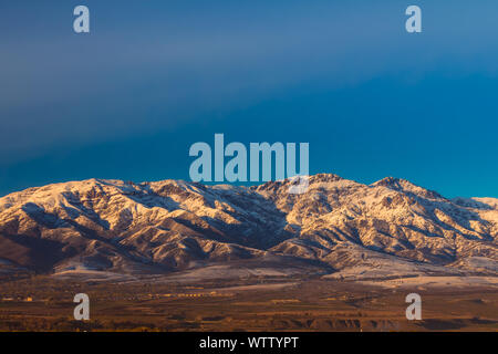 Picturesque chain of mountain alps partially covered by snow at sunset, late fall Stock Photo