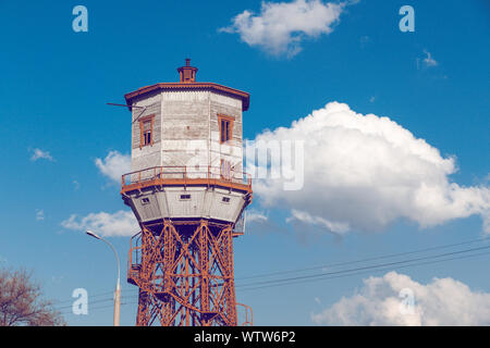 Old wooden water tower with keeper room over blue sky Stock Photo - Alamy