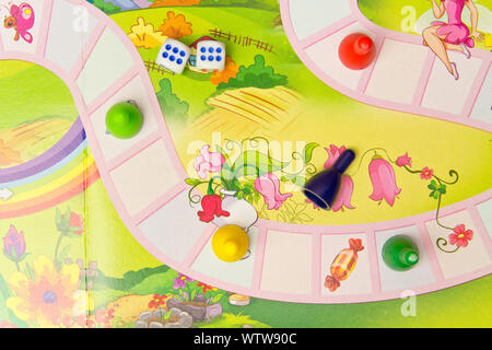 Board games for the home. Colored plastic chips and dice on the background of board games . Selective focus Stock Photo
