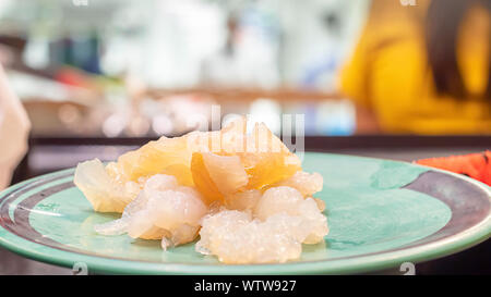 The jellyfish live on green plastic plate Stock Photo