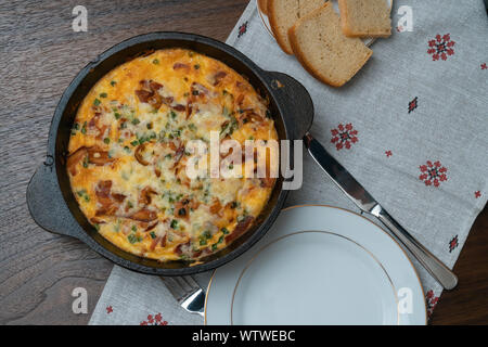 Breakfast - baked omelette in pan with vegetables served Stock Photo