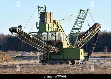 Stone crusher in the quarry. Working mining machine - stone crusher. Quarrying of stones for construction works. Mining industry Stock Photo