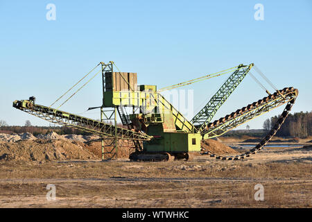 Stone crusher in the quarry. Working mining machine - stone crusher. Quarrying of stones for construction works. Mining industry Stock Photo
