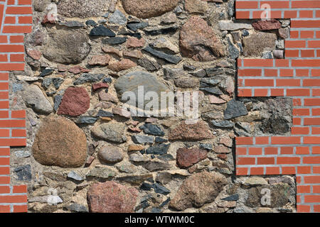 Stones and red bricks wall, architecture background Stock Photo