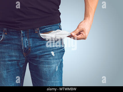 Poor man in jeans with empty pocket Stock Photo