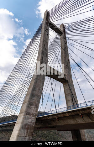 Modern suspension bridge. Detail of tower and steel cables. Barrios de Luna, Castile and Leon, Spain. Stock Photo