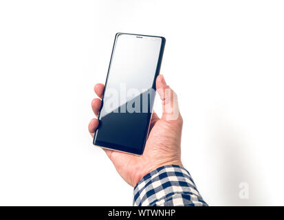 Male hand holding big smartphone with blank screen, business concept Stock Photo