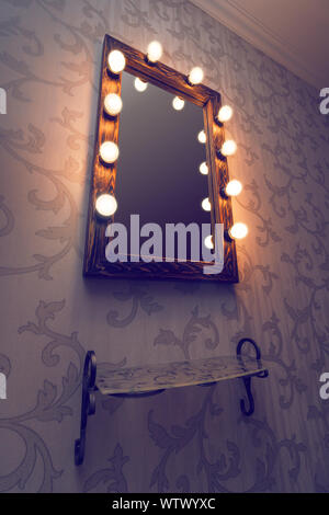 Woman's makeup place with mirror and empty shelf Stock Photo