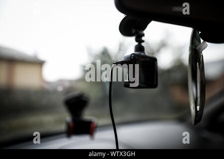 Car video recorder (car dash camera). Video recorder under view mirror in  car .Soft focus Stock Photo - Alamy