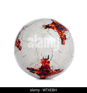 Close up studio shot of white with orange markings soccer ball, isolated on white background. Stock Photo