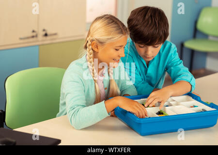 Boy and girl looking for details before building. Stock Photo