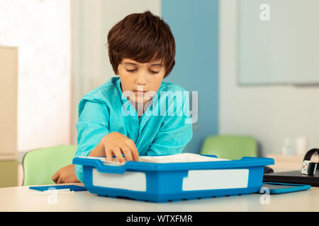 Thoughtful boy going to make new school project. Stock Photo