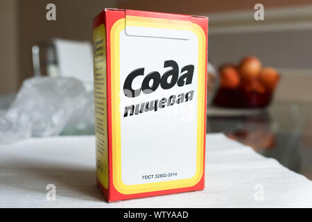 Baking soda in a paper box. Branded packaging of soda in the kitchen Stock Photo