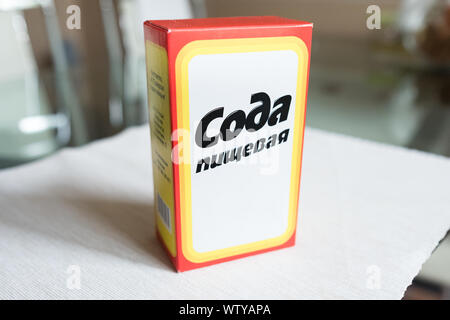 Baking soda in a paper box. Branded packaging of soda in the kitchen Stock Photo