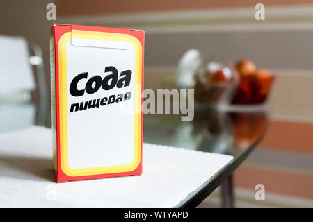 Baking soda in a paper box. Branded packaging of soda in the kitchen Stock Photo