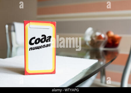 Baking soda in a paper box. Branded packaging of soda in the kitchen Stock Photo