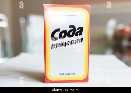 Baking soda in a paper box. Branded packaging of soda in the kitchen Stock Photo