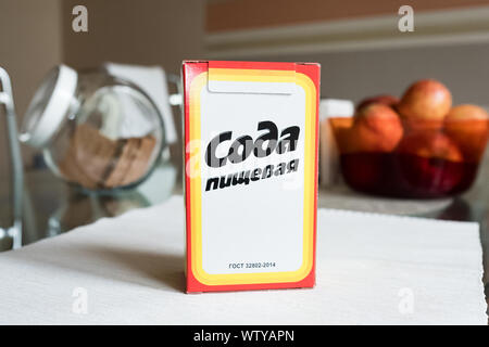 Baking soda in a paper box. Branded packaging of soda in the kitchen Stock Photo