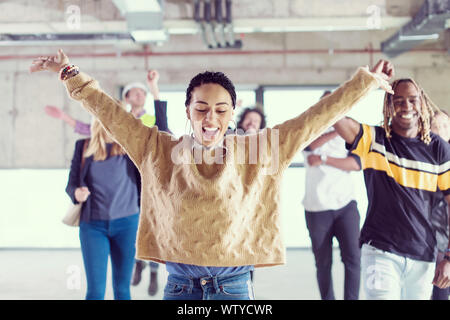 happy multiethnic business team dancing during moving in at new unfinished startup office building Stock Photo