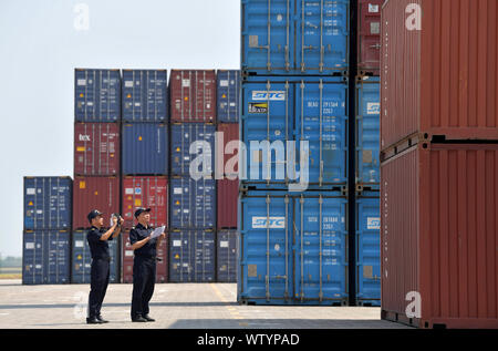 Nanchang. 11th Sep, 2019. Photo taken on Sept.11, 2019 shows customs officers inspecting containers at Longtougang Port in Nanchang City, east China's Jiangxi Province, Sept.11, 2019. Nanchang has been actively constructing the ports along the Yangtze River in recent years in an effort to facilitate trade with the outside world. It explored a variety of approaches to reduce service fee, improve efficiency and promote the development of transportation and logistics. Credit: Peng Zhaozhi/Xinhua/Alamy Live News Stock Photo