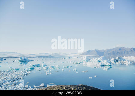 A beautiful glacier somewhere in breathtaking Iceland. Sea ice floes and snowy glacier scenery at the geyser glacial lake in Iceland under the blue sk Stock Photo