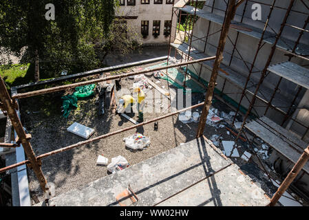 Men on the construction site performing work in uniforms. Stock Photo