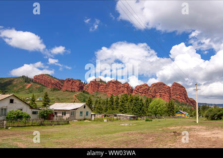 Rock Broken Heart in the Jeti Oguz gorge Kyrgyzstan with white yurts in the foreground Stock Photo