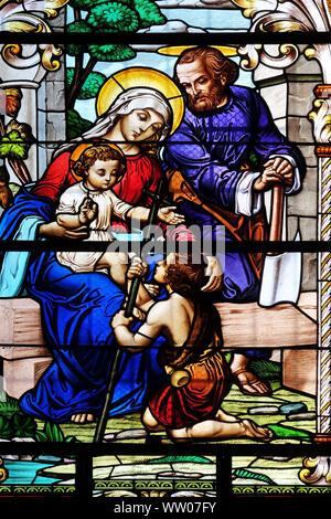 Holy Family with St. John the Baptist, stained glass window in the Saint John the Baptist church in Zagreb, Croatia Stock Photo