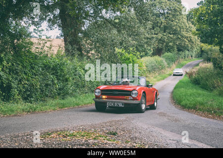 1972 Triumph TR6 going to a classic car show in the Oxfordshire countryside. Broughton, Banbury, England. Vintage filter applied Stock Photo
