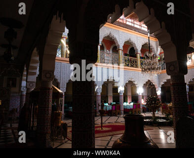 MARRAKESH, MOROCCO - JAN 2019: Inner hall of Riad in Marrakesh, Morocco. Rich riad interior Moroccan style arch stairs and mosaic