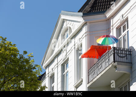 colorful sunshades on balcony of old residential building Stock Photo