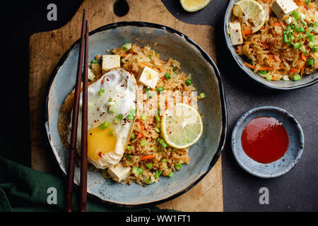 Vegetarian fried rice with tofu, peas and vegetables. Asian cuisine, healthy lunch Stock Photo