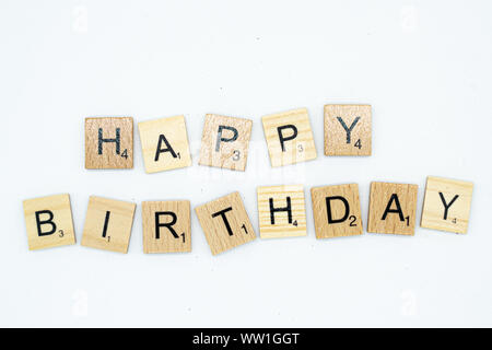 Isolated happy birthday message spelt in scrabble letters on white background Stock Photo