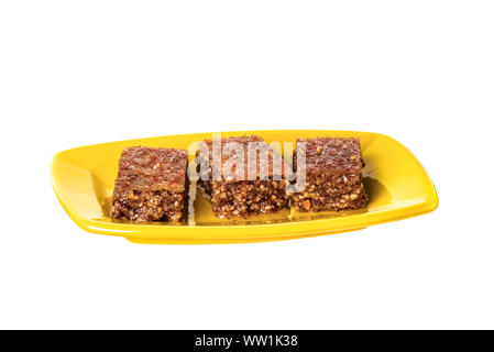 Pieces of Sheki halva on a plate isolated on white Stock Photo