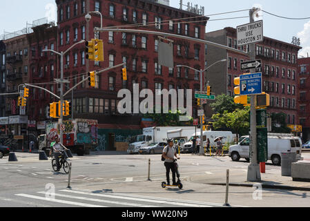 New York street scene, view in summer of people crossing Delancey Street in the Lower East Side of Manhattan, New York City, USA Stock Photo